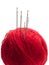 Many needles in a red yarn ball