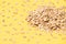 Many of oat flakes. Yellow background. Healthy eating