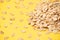 Many of oat flakes. Yellow bright background. Healthy eating