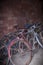 Many old or antique bicycles stacked in a garage