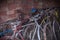 Many old or antique bicycles stacked in a garage