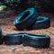 Many old car tires lying in forest