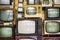 Many old televisions bundled together. A wall of old vintage tube televisions