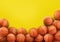 Many orange basketball balls on yellow background. Space for text