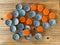 Many orange beer lids, bottle corks tops on a wooden texture top view