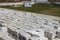 Many packages of autoclaved aerated concrete on pallets put one on the other on an outdoor factory warehouse. Top view of