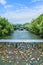 Many padlocks on bridge with view of the artificial island on the Mur river in Graz