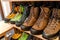 Many pairs of hiking, trekking and mountaineering boots for sale at travel shop