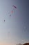 Many paragliders simultaneously is flying in a clear blue sky