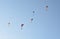 Many paragliders simultaneously is flying in a clear blue sky