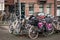 Many parked bicycles in the city.