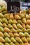 Many pears arranged on a counter in a fruit shop