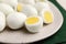 Many peeled hard boiled quail eggs on plate, closeup