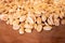 Many peeled peanuts on wooden