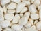 many peeled white cloves of garlic - background