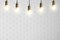 Many pendant lamps against white brick wall