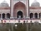 Many people in the ablutions area next to the main entrance of the Jama Masjid Mosque in New Delhi, India