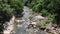 Many people come to waterfall after end of COVID-19 quarantine. Travel after quarantine. People playing in the stream. aerial view