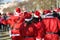 many people with red dress of Santa Claus during a sport race