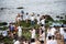 Many people are on the rocks of Rio Vermelho beach offering gifts to Iemanja