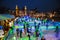 Many people skate on winter ice skating rink at night in front of the Rijksmuseum, a popular touristic destination in Amsterdam