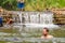 Many people swimming at the small weir irrigate