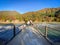 Many people waking on the bridge over Shogawa River in autumn