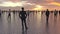 Many people walk and stand on the water surface. Human silhouettes on a background of a sunset on a calm sea. Superpowers of a