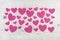 Many pink hearts on wooden shabby chic white background for vale