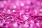 Many pink little crystal hearts with bokeh background.