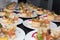 Many plates of appetizers being prepared in commercial kitchen, for an event, selective focus