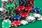 Many poker chips isolated on a green background