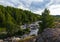 Many rapids with waterfalls, spray foam and whirlpools close-up, rotate camera. Ural region, Russia. The threshold Revun