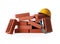 Many red bricks, hard hat and trowel on white background