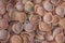 A many red brown ceramic small plates lying in a pile. rough surface texture