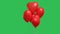 Many red heart shaped balloons hanging in the air against the background of a green screen chroma key. Close up of