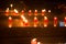 Many red votive candles light the darkness in church