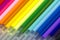 Many refills of a colored pens close-up. Rainbow multicolor pattern. Blurred and defocused background