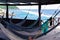 Many relaxing hammocks under a bungalow, with a blurred ocean background in Tairona National Park, Colombia