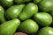 Many ripe avocados as background