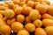 Many ripe orange fruit of citrus fortunella in a pile on a plate or tray