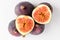 Many ripe organic figs displayed on a white plate on a table, close up of healthy vegan food photographed with soft focus