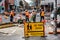 Many road workers in orange vests