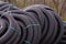 Many rolled coils of new black corrugated goffred plastic electric plumbing drainage pipe prepared for installation near building