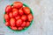 Many Roma tomatoes in a basket