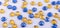 Many round yellow and blue sewn stones on a white background