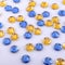 Many round yellow and blue sewn stones on a white background
