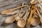 Many rustic wooden kitchen utensils close up.