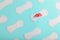 Many Sanitary pads on a blue background in the form of a diagonal pattern with a flower. Textured background all over the screen