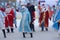 Many Santa Clauses and Snow Maidens dance together, a flash mob